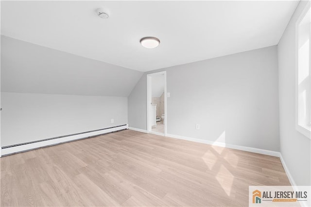 bonus room featuring light wood-style flooring, a baseboard radiator, baseboards, and lofted ceiling