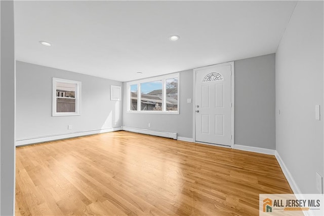 interior space featuring baseboards, recessed lighting, wood finished floors, and baseboard heating