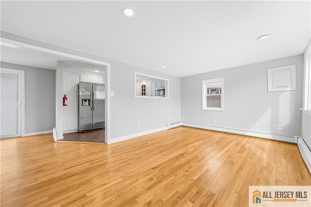unfurnished living room featuring baseboards, recessed lighting, a baseboard heating unit, and light wood-style floors