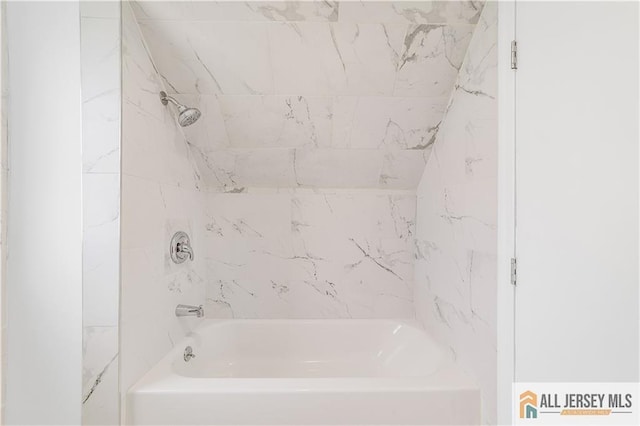 bathroom with bathing tub / shower combination