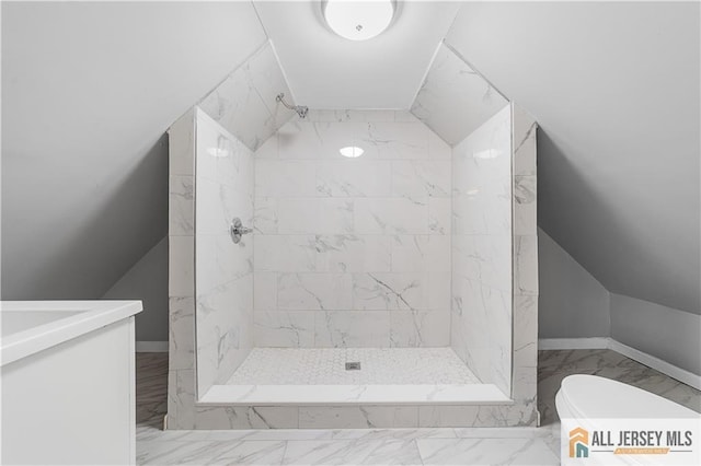 bathroom with toilet, a stall shower, marble finish floor, and vaulted ceiling