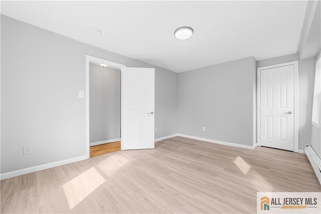 unfurnished bedroom with baseboards and light wood finished floors