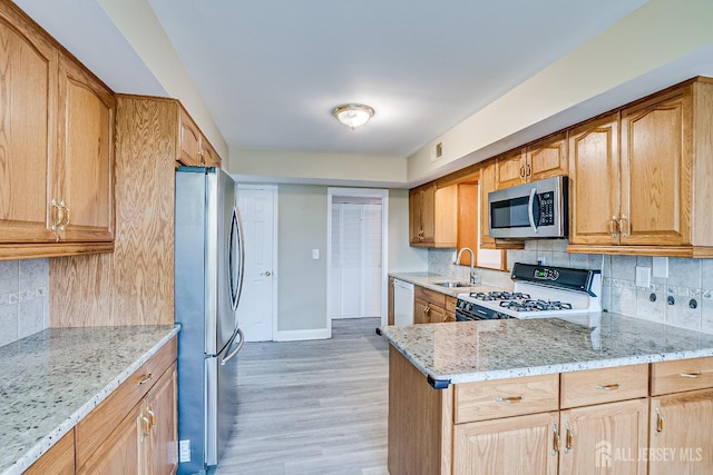 86 Bunker Hill Rd, Lawrence, NJ 08648 - kitchen featuring stainless steel appliances, decorative backsplash, light stone counters, and light wood-style flooring