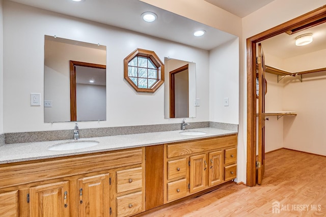 86 Bunker Hill Rd, Lawrence, NJ 08648 - bathroom featuring double vanity, wood finished floors, recessed lighting, and a walk in closet