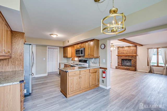 86 Bunker Hill Rd, Lawrence, NJ 08648 - kitchen with stainless steel appliances, a chandelier, a brick fireplace, open floor plan, and light wood finished floors