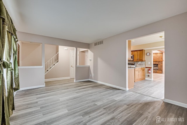 86 Bunker Hill Rd, Lawrence, NJ 08648 - unfurnished living room featuring light wood-style floors and stairs