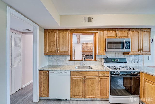 86 Bunker Hill Rd, Lawrence, NJ 08648 - kitchen featuring dishwasher, stainless steel microwave, range with gas cooktop, light stone counters, and backsplash