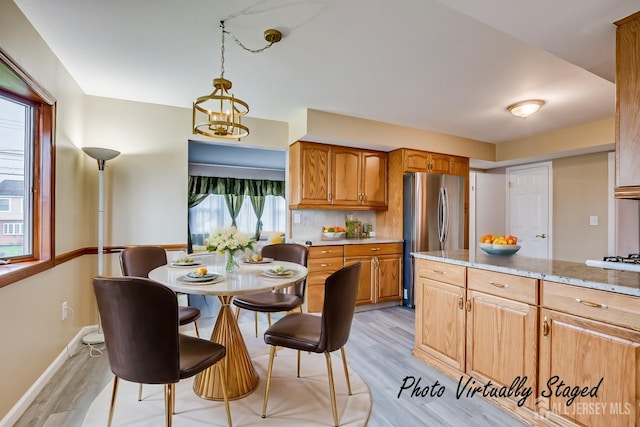 86 Bunker Hill Rd, Lawrence, NJ 08648 - kitchen with freestanding refrigerator, light wood-type flooring, brown cabinetry, light stone counters, and pendant lighting
