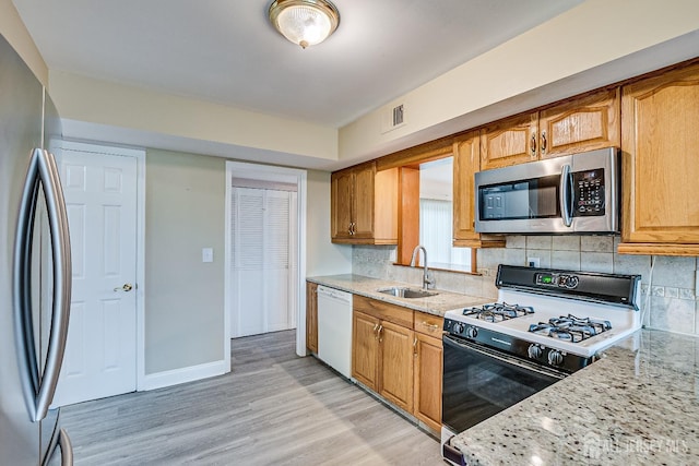 86 Bunker Hill Rd, Lawrence, NJ 08648 - kitchen with stainless steel appliances, light wood finished floors, decorative backsplash, and light stone countertops