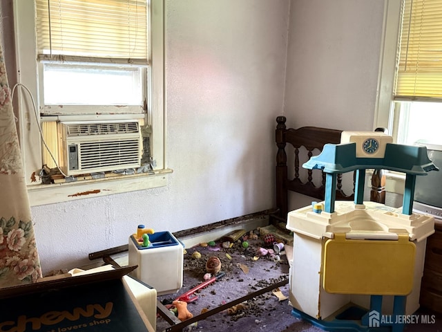 miscellaneous room featuring cooling unit and a textured wall