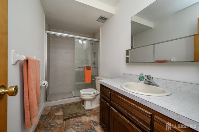 101 Mandon Ct Unit 4, South Brunswick, NJ 08540 - bathroom featuring toilet, vanity, a stall shower, and stone finish floors