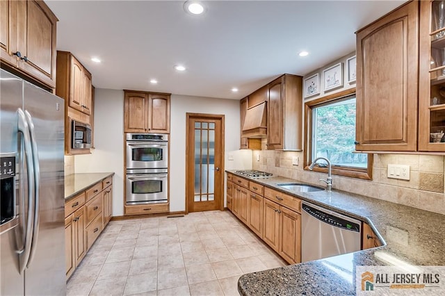 13 Steven Rd, South Brunswick, NJ 08824 - kitchen featuring appliances with stainless steel finishes, a sink, custom range hood, stone countertops, and decorative backsplash