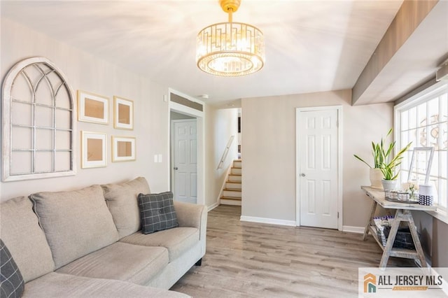 1516 N Indian Pl, North Brunswick, NJ 08902 - living area with a chandelier, stairs, and wood finished floors