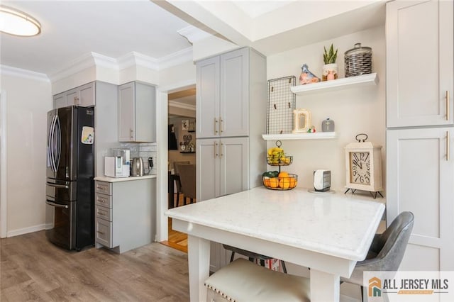 1516 N Indian Pl, North Brunswick, NJ 08902 - kitchen featuring freestanding refrigerator, gray cabinets, open shelves, light wood-type flooring, and a breakfast bar area
