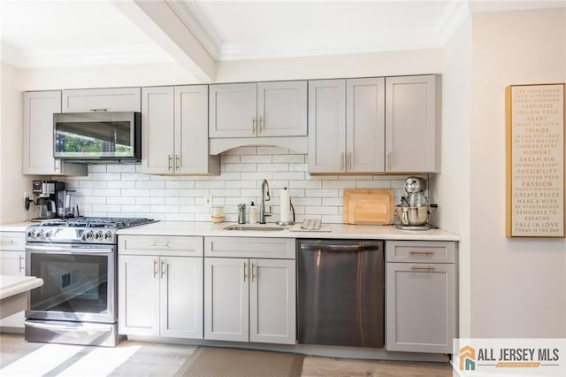 1516 N Indian Pl, North Brunswick, NJ 08902 - kitchen with stainless steel appliances, gray cabinets, ornamental molding, and backsplash