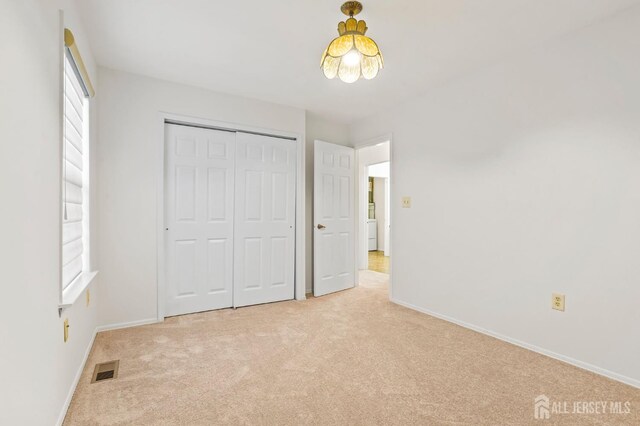 123 Concordia Cir Unit G, Monroe, NJ 08831 - unfurnished bedroom with light colored carpet, baseboards, and a closet