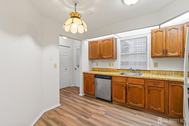 123 Concordia Cir Unit G, Monroe, NJ 08831 - kitchen with stainless steel dishwasher, a sink, light wood-type flooring, and brown cabinets