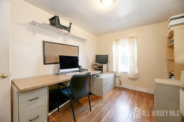 office space featuring baseboards and hardwood / wood-style flooring
