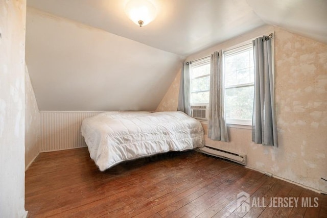 bedroom with wood-type flooring, lofted ceiling, a baseboard radiator, and cooling unit