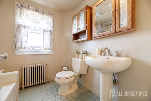 full bath with radiator, tile patterned floors, toilet, baseboards, and a bathtub