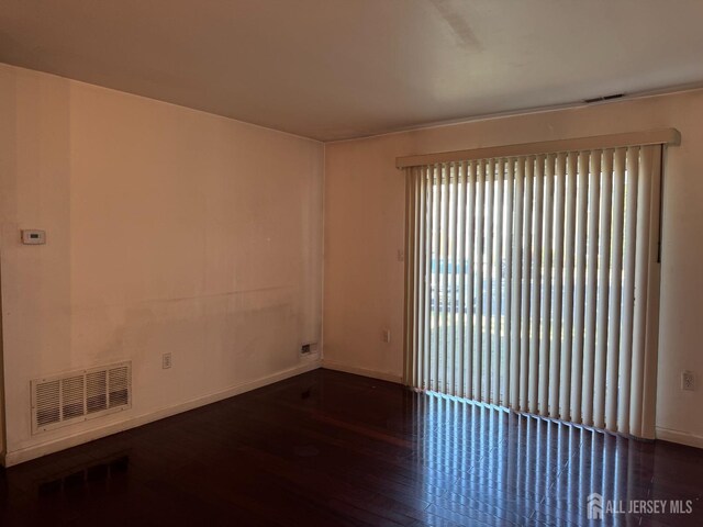 unfurnished room featuring dark hardwood / wood-style floors