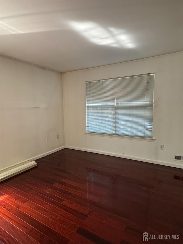 unfurnished room featuring dark hardwood / wood-style flooring