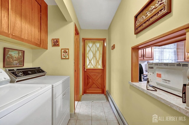 laundry area featuring cabinet space, light tile patterned floors, baseboards, a baseboard radiator, and washing machine and clothes dryer