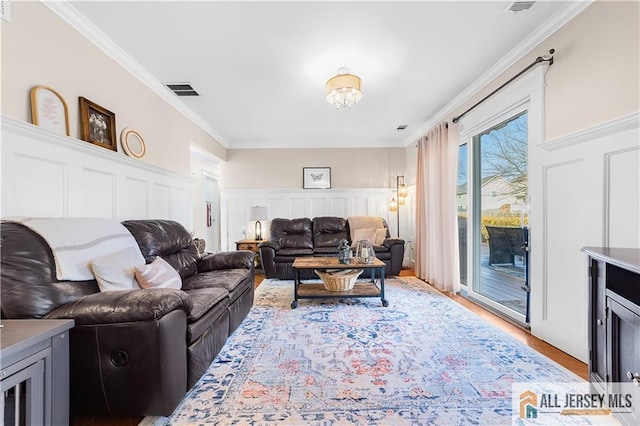 8 N Rhoda St, Monroe, NJ 08831 - living room featuring crown molding, light wood finished floors, and a decorative wall