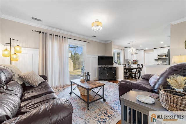 8 N Rhoda St, Monroe, NJ 08831 - living room with ornamental molding, wood finished floors, and a chandelier