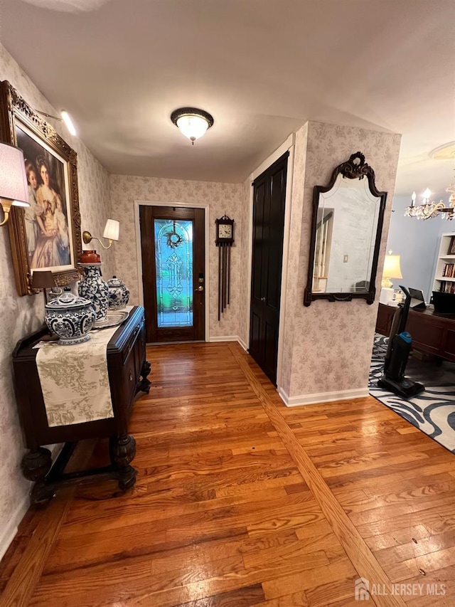 520 Albermarle St, Rahway, NJ 07065 - foyer with wood finished floors, wallpapered walls, and a chandelier