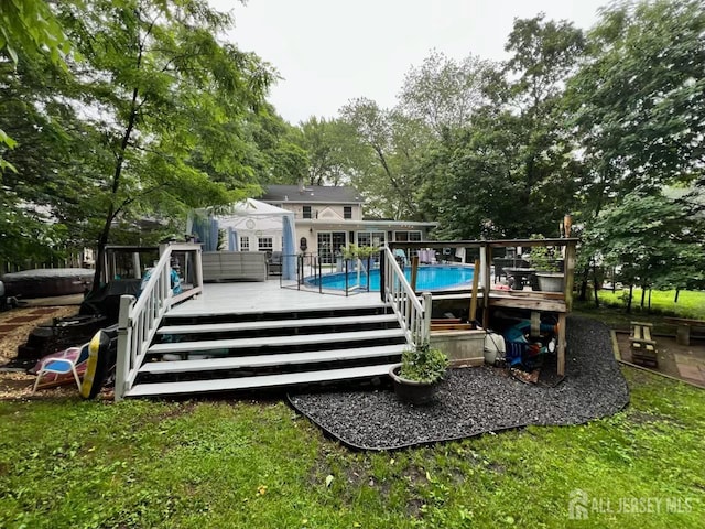 520 Albermarle St, Rahway, NJ 07065 - rear view of house featuring a deck, an outdoor pool, and view of scattered trees