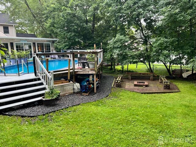 520 Albermarle St, Rahway, NJ 07065 - view of green lawn featuring an outdoor fire pit, an outdoor pool, and a wooden deck