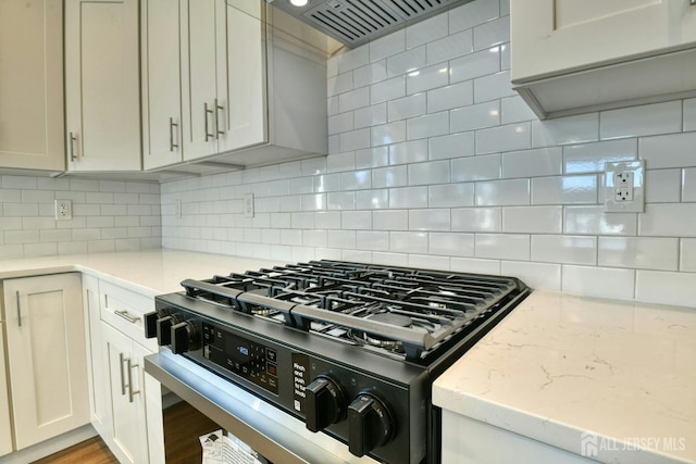 1032 3rd Ave, Manchester, NJ 08757 - kitchen with stainless steel range with gas cooktop, custom exhaust hood, tasteful backsplash, and light stone counters