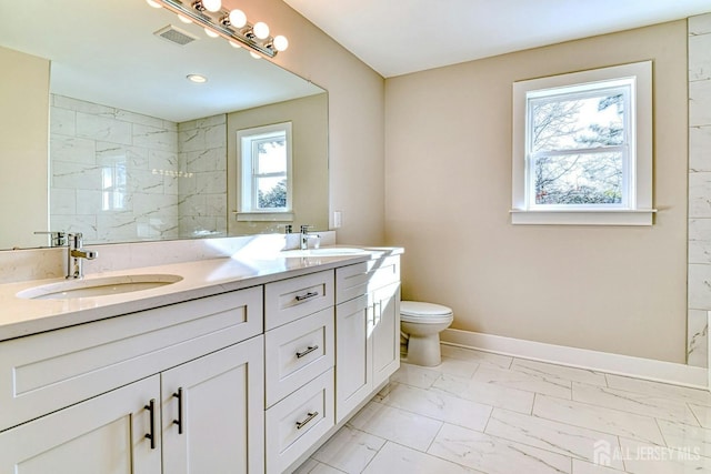 1032 3rd Ave, Manchester, NJ 08757 - bathroom with marble look tiles, toilet, double vanity, baseboards, and a tile shower