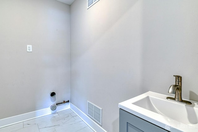 1032 3rd Ave, Manchester, NJ 08757 - laundry area featuring light marble finish flooring and baseboards