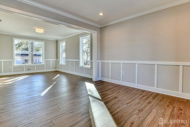 1032 3rd Ave, Manchester, NJ 08757 - unfurnished room with wood finished floors, wainscoting, crown molding, a decorative wall, and recessed lighting