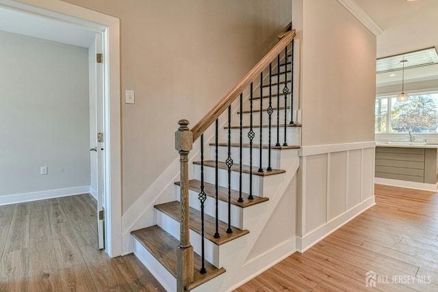 1032 3rd Ave, Manchester, NJ 08757 - stairs featuring wood finished floors, crown molding, and baseboards