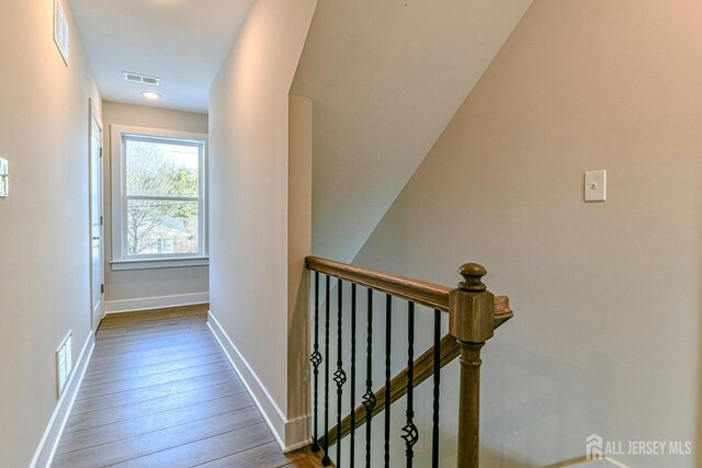 1032 3rd Ave, Manchester, NJ 08757 - hallway with an upstairs landing, baseboards, and wood-type flooring
