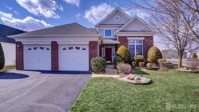 view of front facade with aphalt driveway, brick siding, roof with shingles, an attached garage, and a front lawn