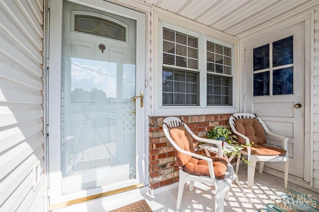 doorway to property featuring brick siding