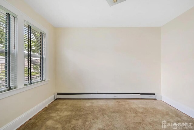 carpeted empty room with baseboards