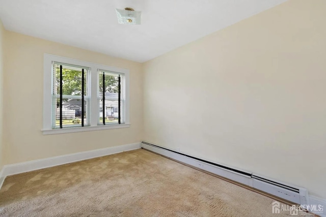 spare room featuring baseboards, carpet floors, and a baseboard radiator