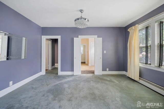 34 Livingston Ave, Avenel, NJ 07001 - unfurnished bedroom with carpet floors, a baseboard radiator, baseboards, and a chandelier