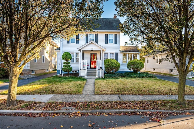 colonial home with a front lawn