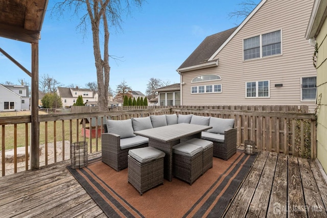 deck featuring a residential view, fence, and a lawn