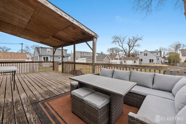wooden deck featuring a residential view and outdoor lounge area