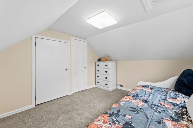 carpeted bedroom with baseboards, visible vents, and lofted ceiling