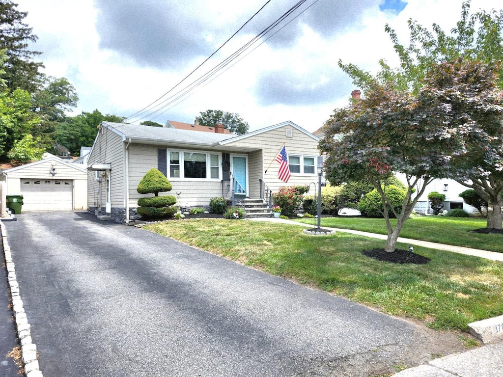 170 Hoover Ave, Edison, NJ 08837 - view of front facade featuring an outbuilding, a detached garage, asphalt driveway, and a front lawn