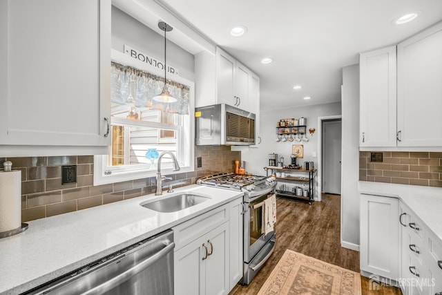 5 Wendy Rd, Woodbridge Proper, NJ 07067 - kitchen featuring stainless steel appliances, a sink, white cabinets, decorative backsplash, and dark wood-style floors
