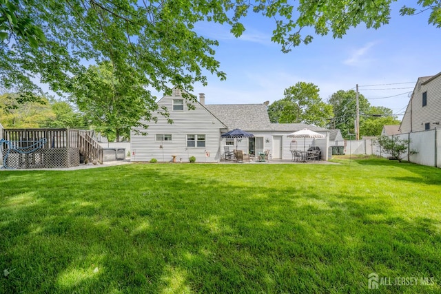 5 Wendy Rd, Woodbridge Proper, NJ 07067 - rear view of house with a wooden deck, a patio area, a chimney, and roof with shingles